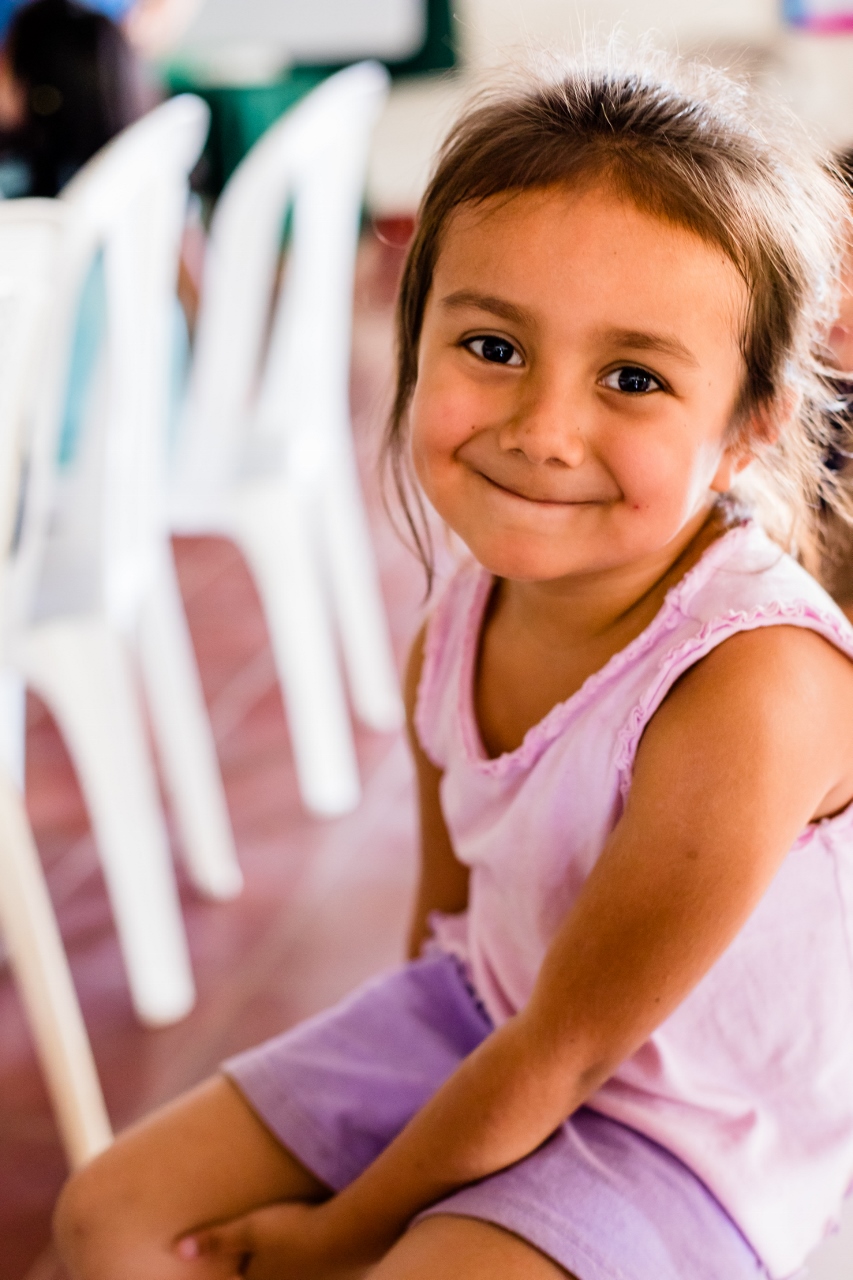 little girl smiling at camera inside Nicaragua church