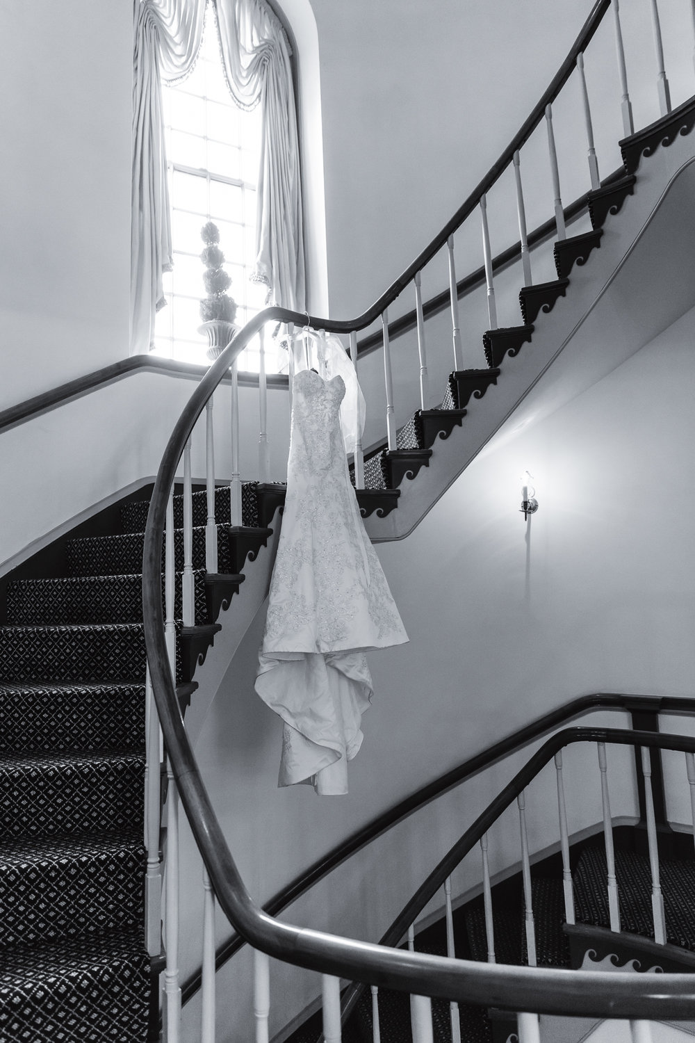 dress hanging in Queen's Staircase at Williamsburg Inn for intimate wedding