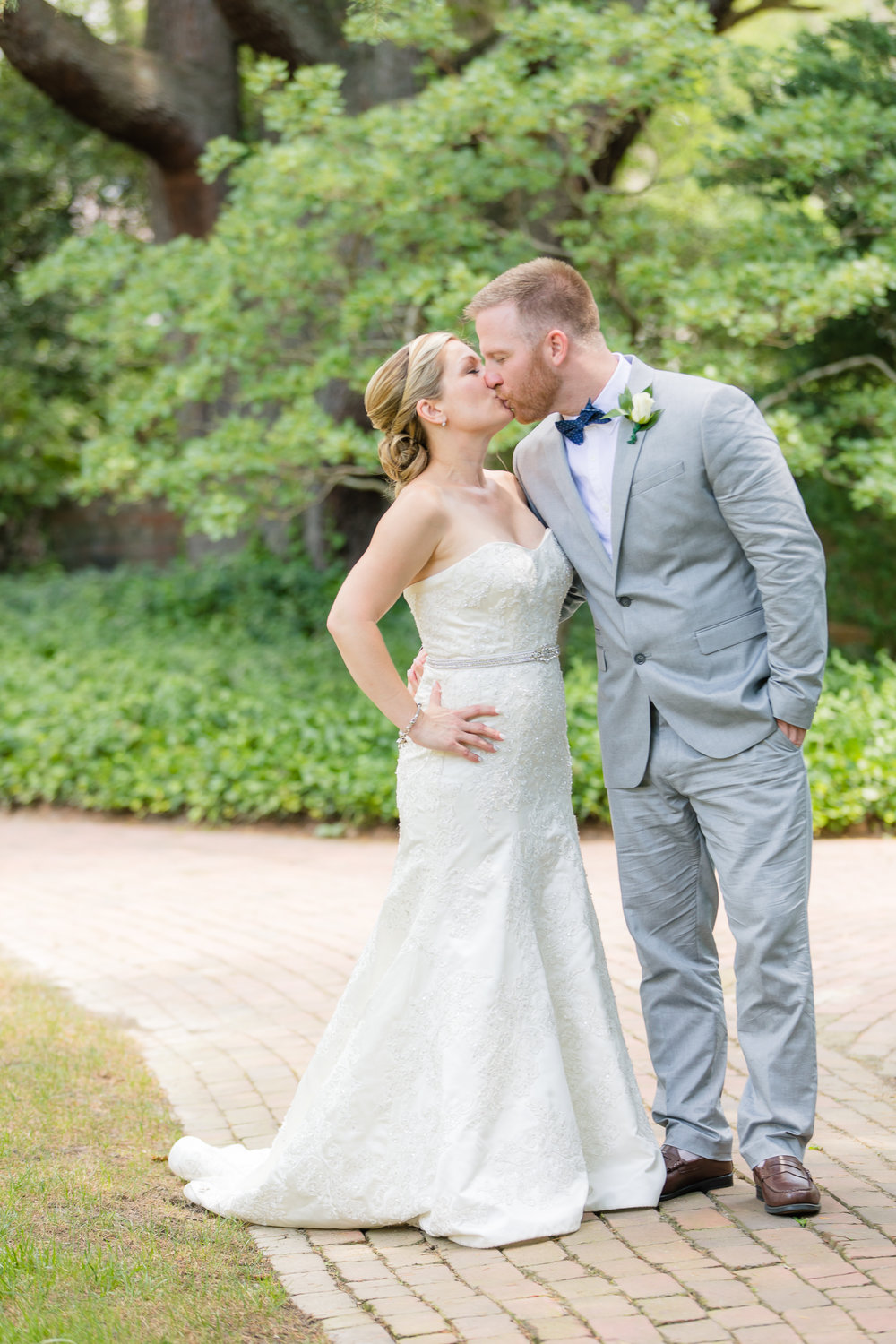 bride kisses groom in Oval Garden