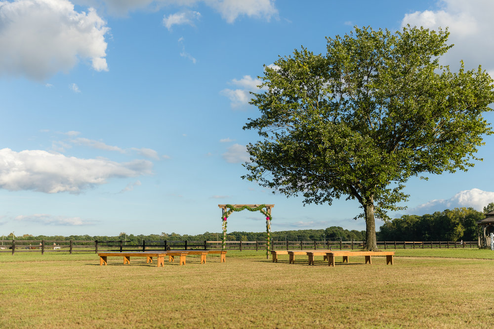 benches and floral arch for outdoor Carlton Farms Wedding