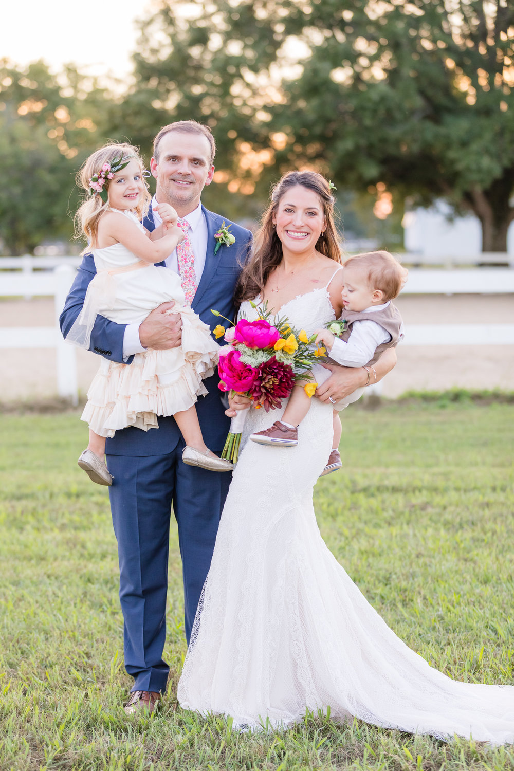 bride and groom with kids for family picture at golden hour