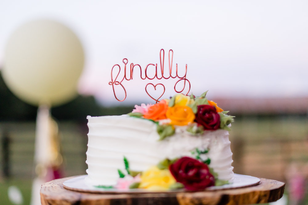fun wedding cake topper with "finally" written