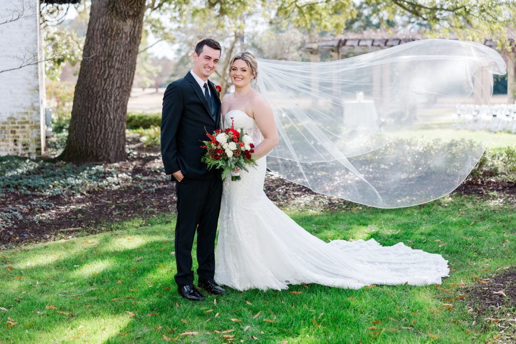 Gorgeous bride with veil behind the Williamsburg Inn with the golf course in the backdrop