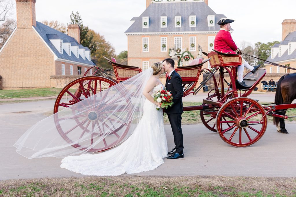 Bride and groom with horse and carriage in front of the historic Governor's Palace