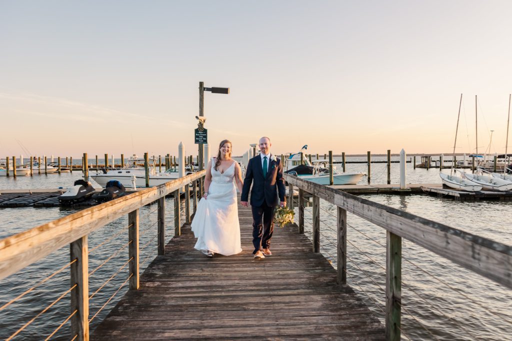 couple walking on dock at the Kingsmill wedding's marina
