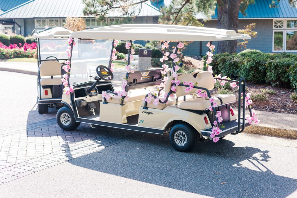 Fun golf cart decorated in pink flowers to celebrate the bride at Kingsmill