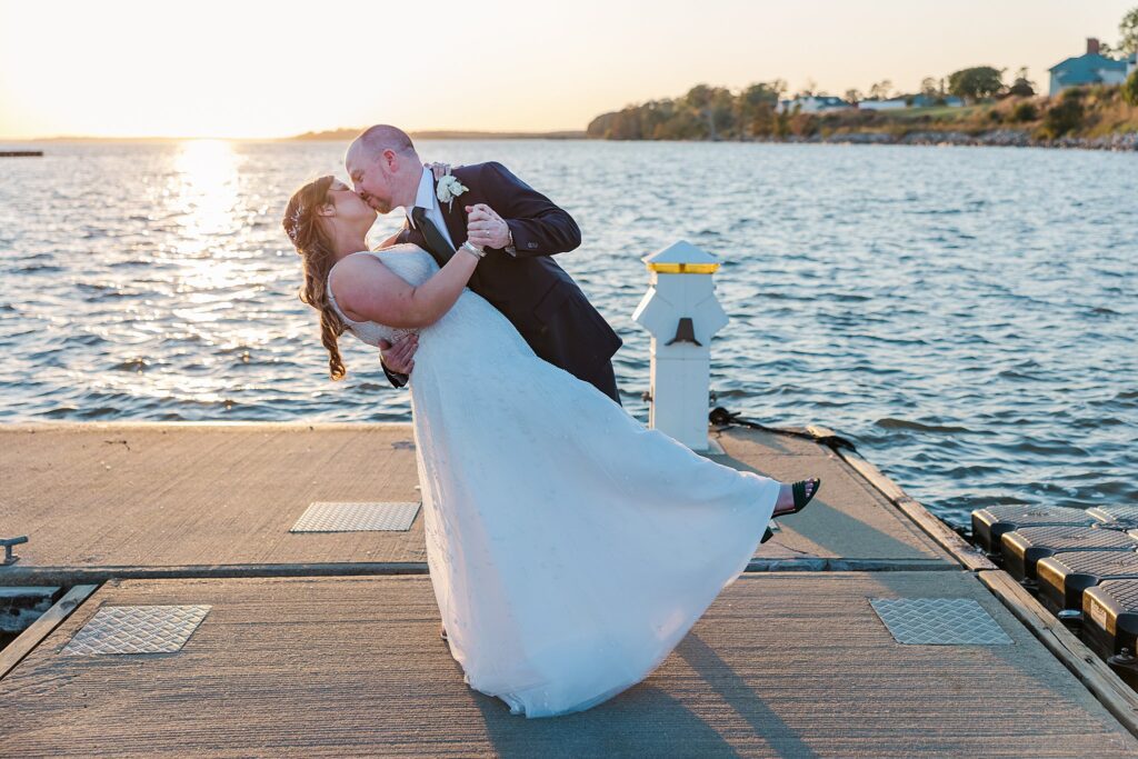 Groom dips bride for kiss at marina for Kingsmill Resort Wedding