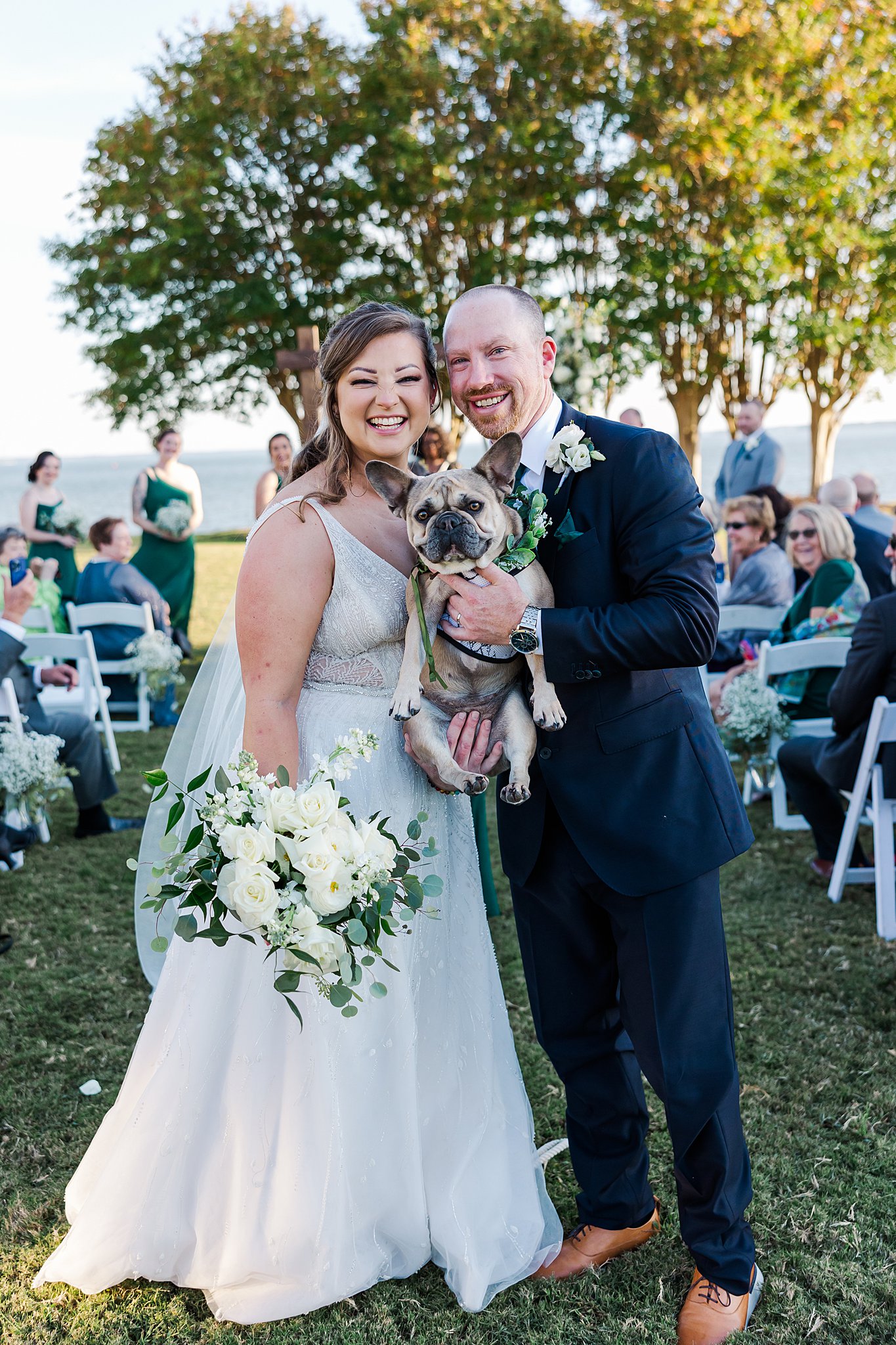 bride and groom smiling after ceremony with their dog at Kingsmill Resort wedding