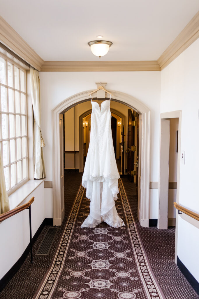 wedding dress hanging in hallway at luxurious Williamsburg Inn