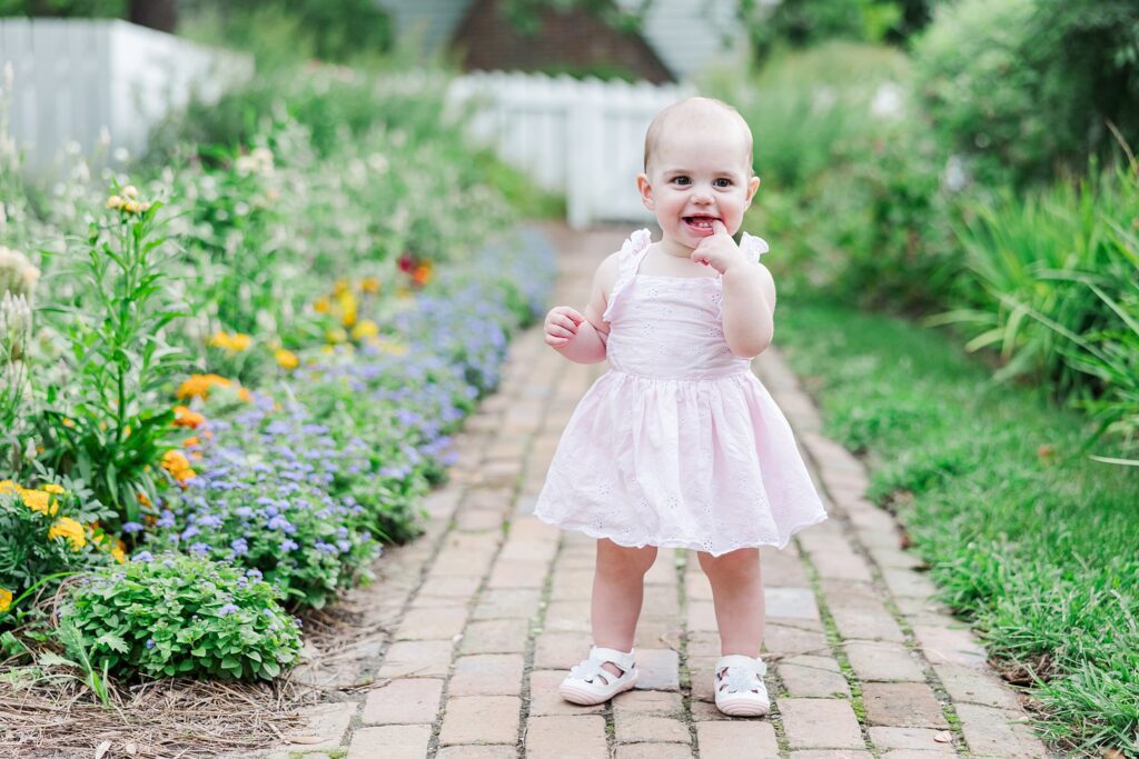 baby outdoors in flower garden for first birthday pictures in Colonial Williamsburg