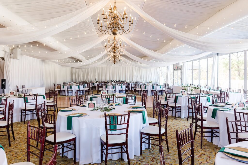 reception space with white curtains and gold chandeliers for a Ford's Colony Wedding in Williamsburg, VA