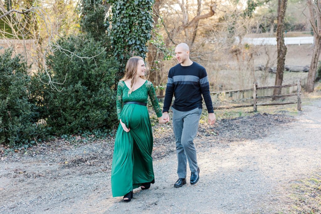 couple walking in Colonial Williamsburg for maternity session by Williamsburg va photographer