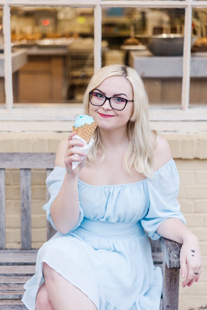 senior in blue dress in front of Williamsburg ice cream shop