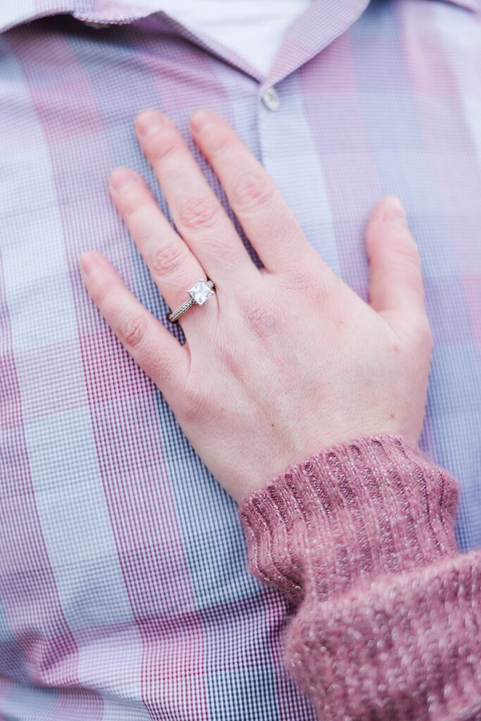 hand on chest highlighting engagement ring