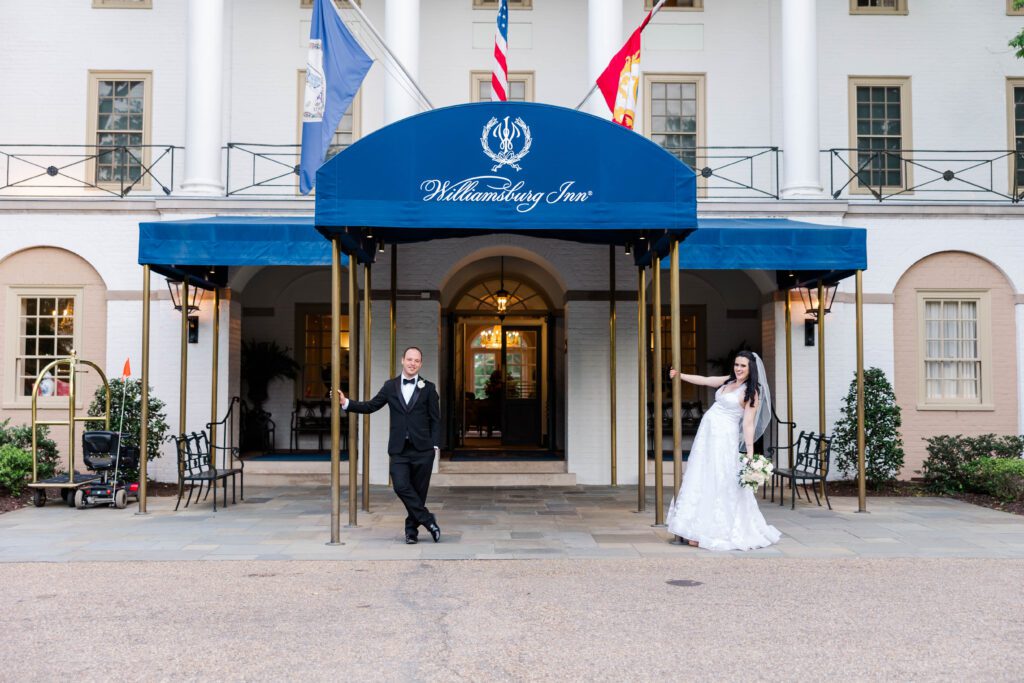Liv and Anthony pose in front of the iconic entrance at their destination wedding at the Williamsburg Inn