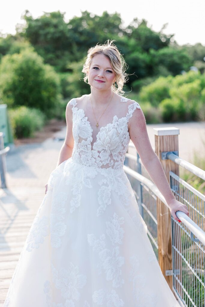 bride stands on bridge for bridal portraits in Virginia Beach