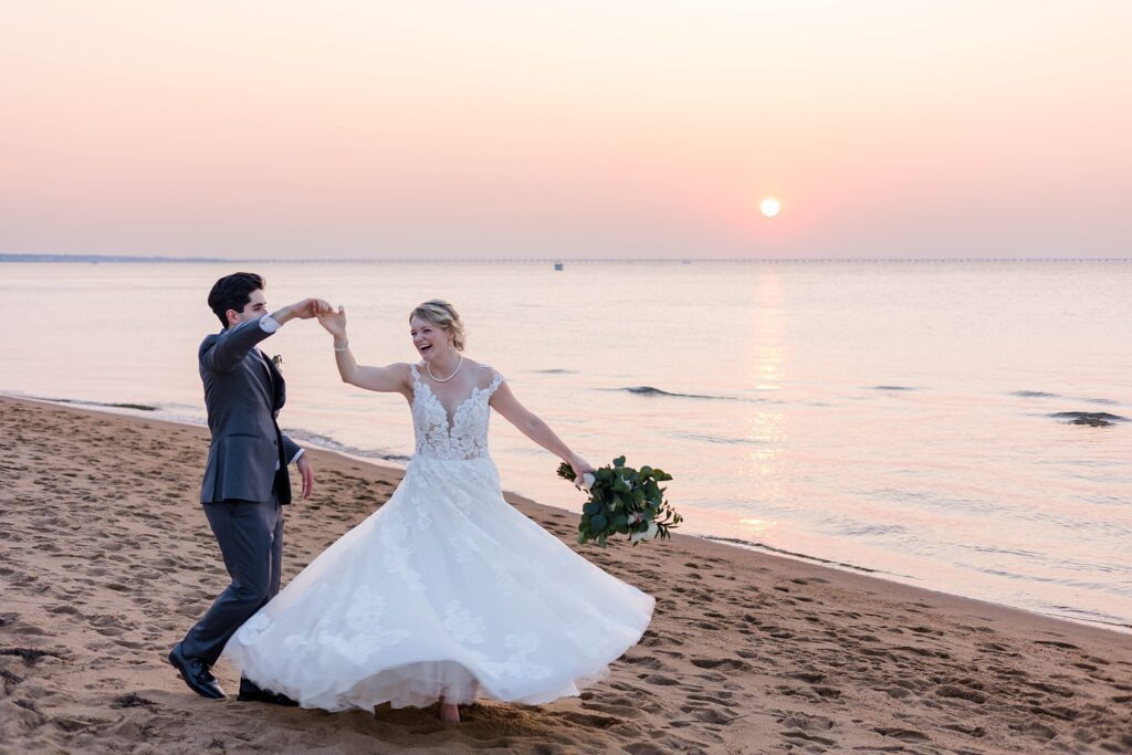 couple dances on beach with sunset after Hampton Roads Wedding in VA Beach