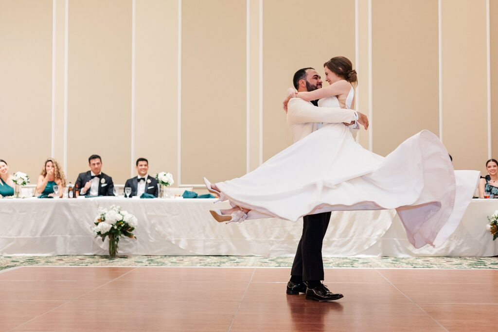 Groom twirls bride and dress swooshes for first dance at William & Mary Alumni House Wedding