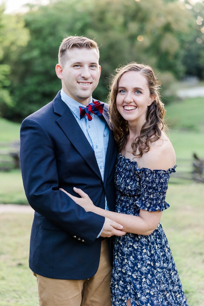 fall engagement session with trees and rustic fence 