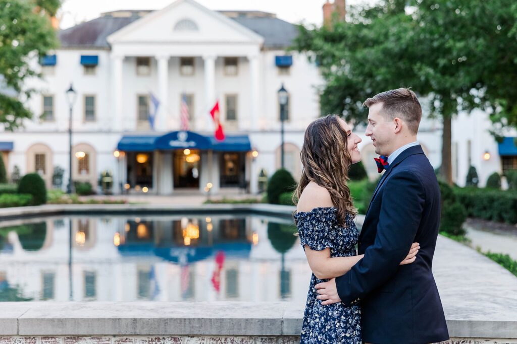 couple gazes into each other's eyes at their fall engagement session at the Williamsburg Inn