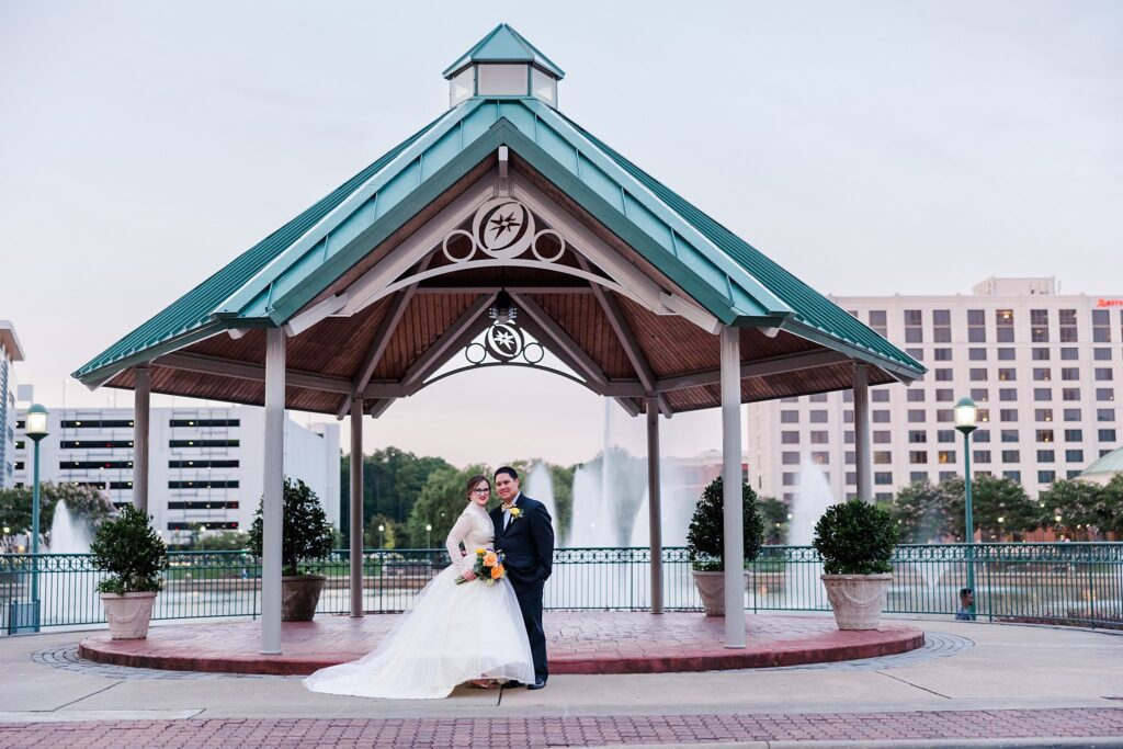 couple stops for posed image in front of gazebo in Newport News for their City Center elopement