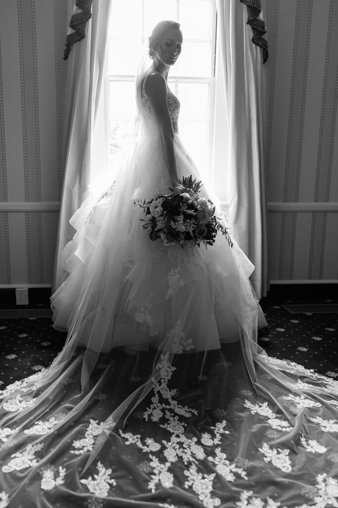 bride poses with veil spread out for epic image 