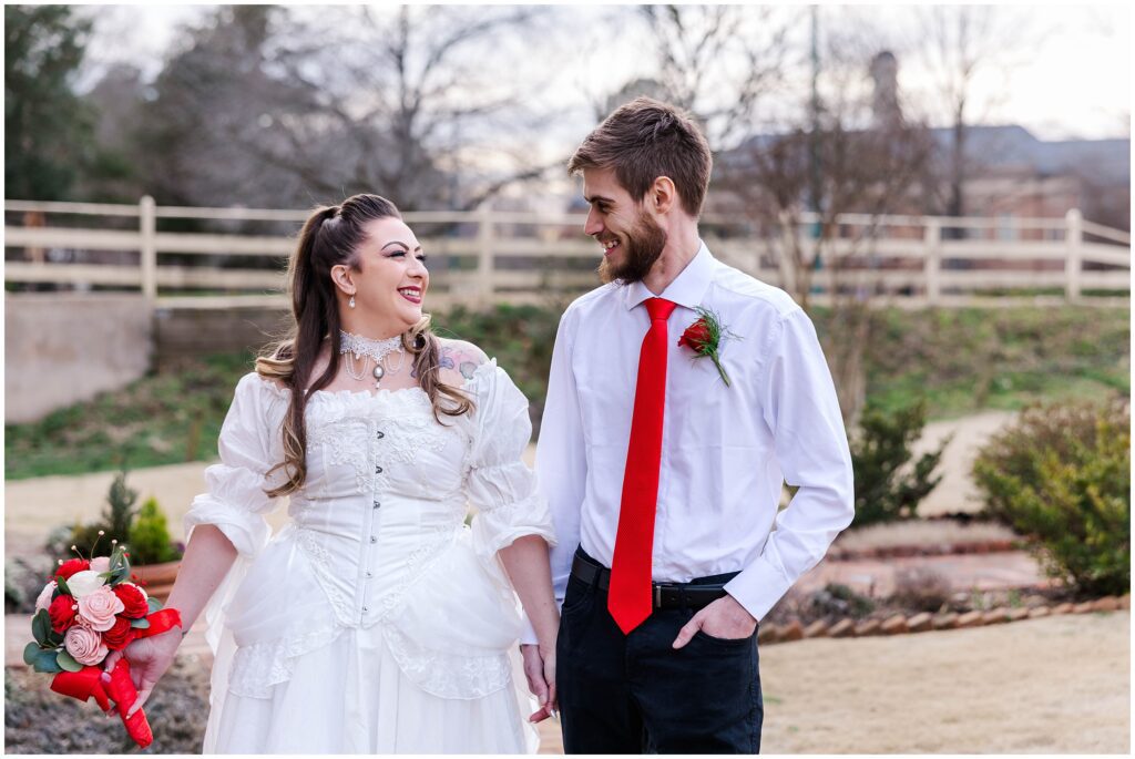 couple smiles in front yard of Cedars of Williamsburg Bed and Breakfast Wedding venue