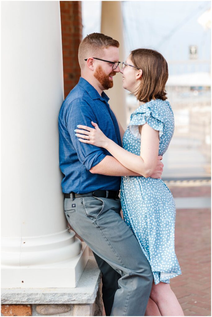 Couple looks into each other's eyes while leaning on Yorktown Beach gazebo