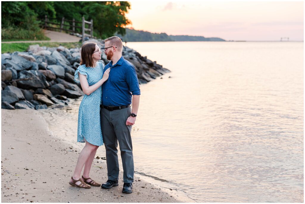 Erica and Chris gaze into each other's eyes during their Yorktown Beach Engagement session at golden hour.