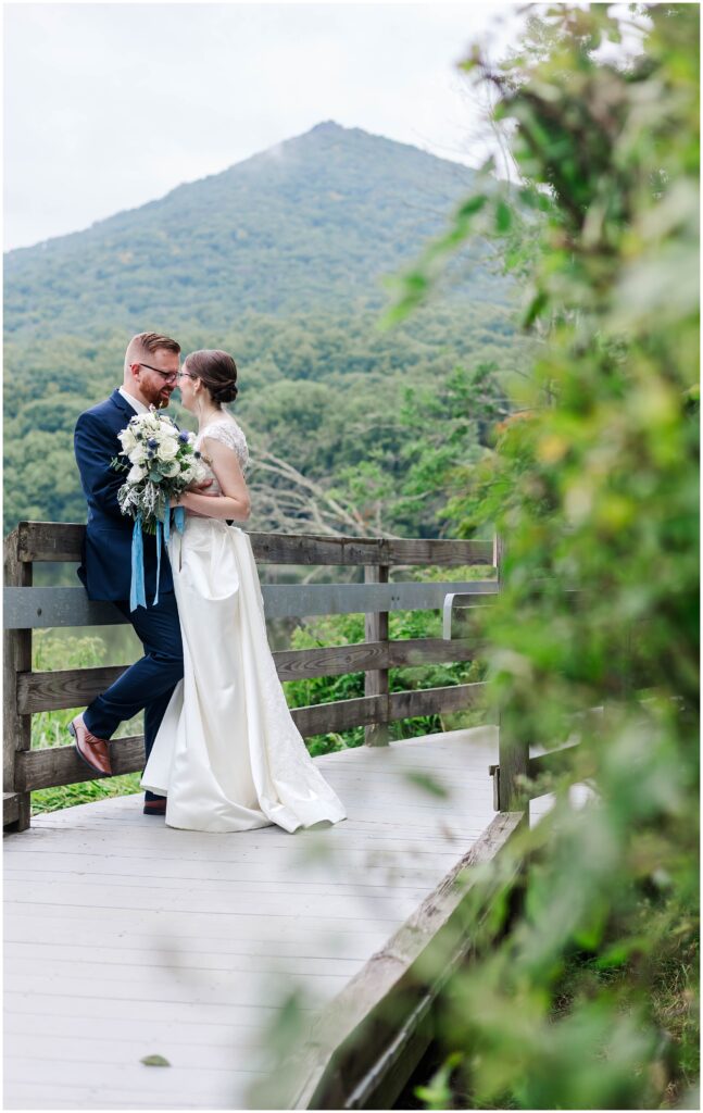 Peaks of Otter behind bride and groom on bridge