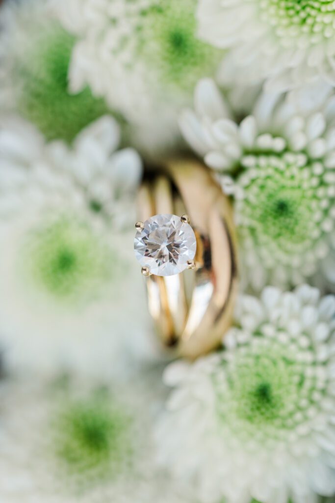 wedding macro photo with white and green florals in background