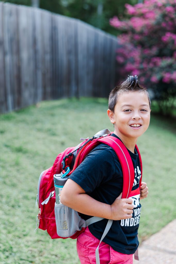 photographing milestones like the first day of school is so special - here is my son with his backpack and mohawk for 5th grade