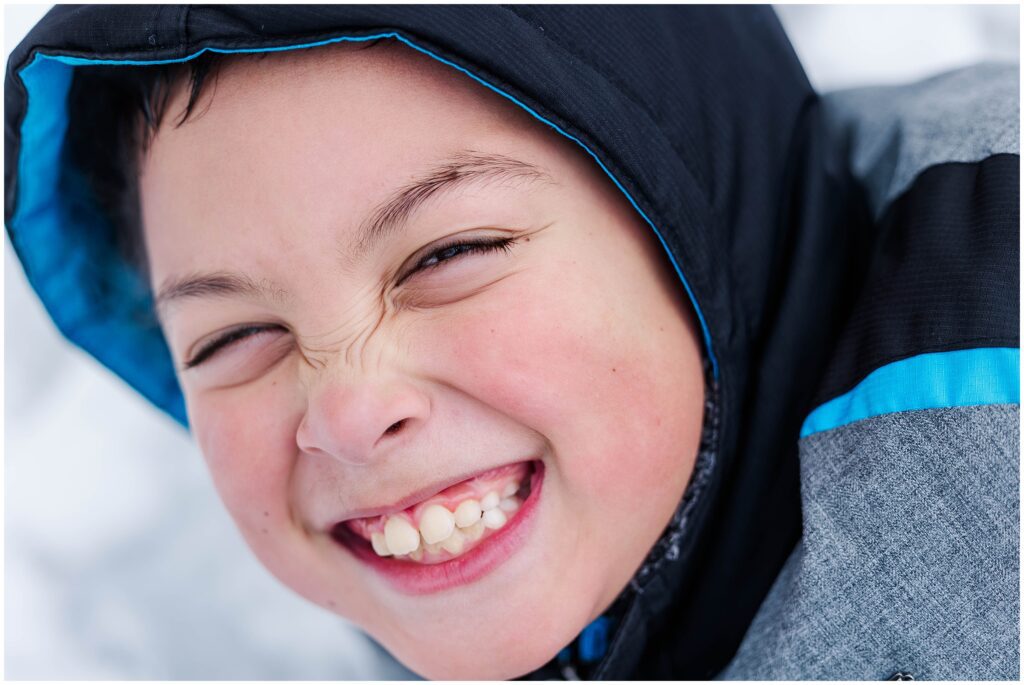 close up image of son playing in snow