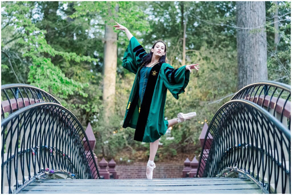 ballet dancer poses on Crim Dell with pointe shoes for senior photos Williamsburg VA