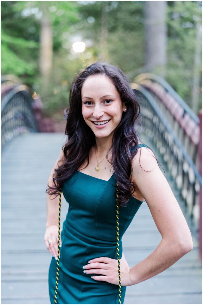 fun portrait at a college senior photo session on the Crim Dell bridge