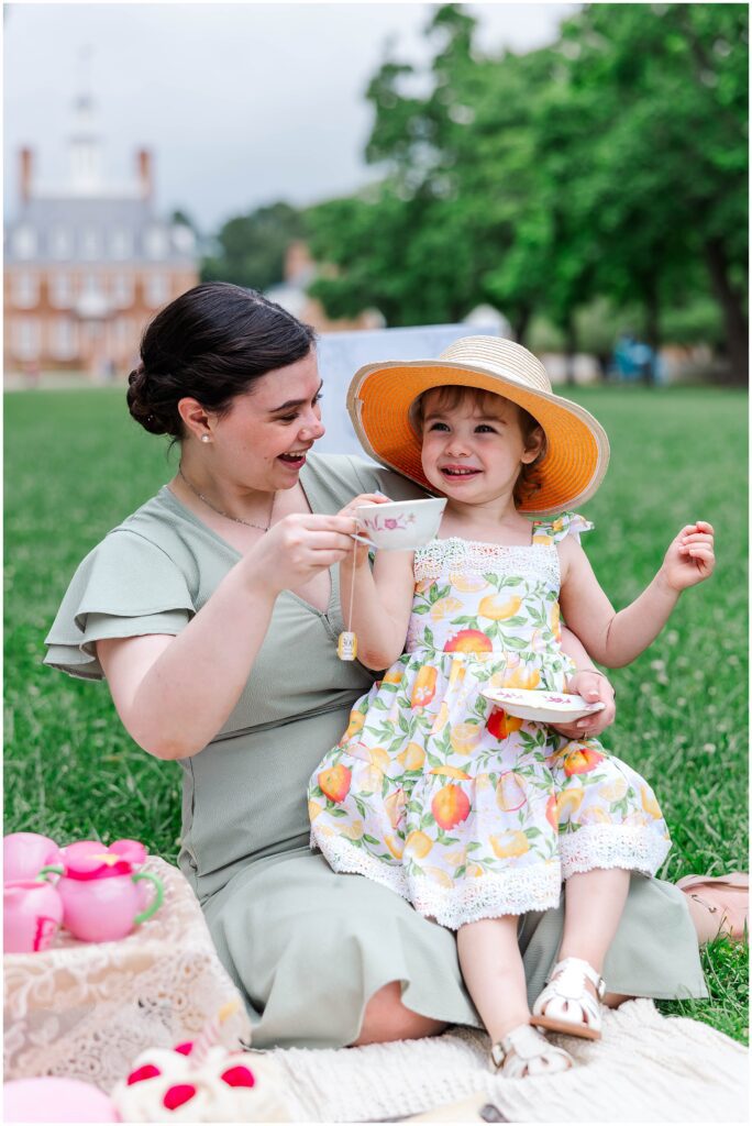 cheers as aunt shares tea cup at first birthday in colonial williamsburg
