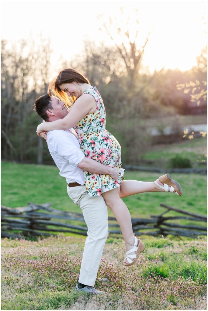 couple lift in glowy spring sunlight for Colonial Williamsburg engagement photos