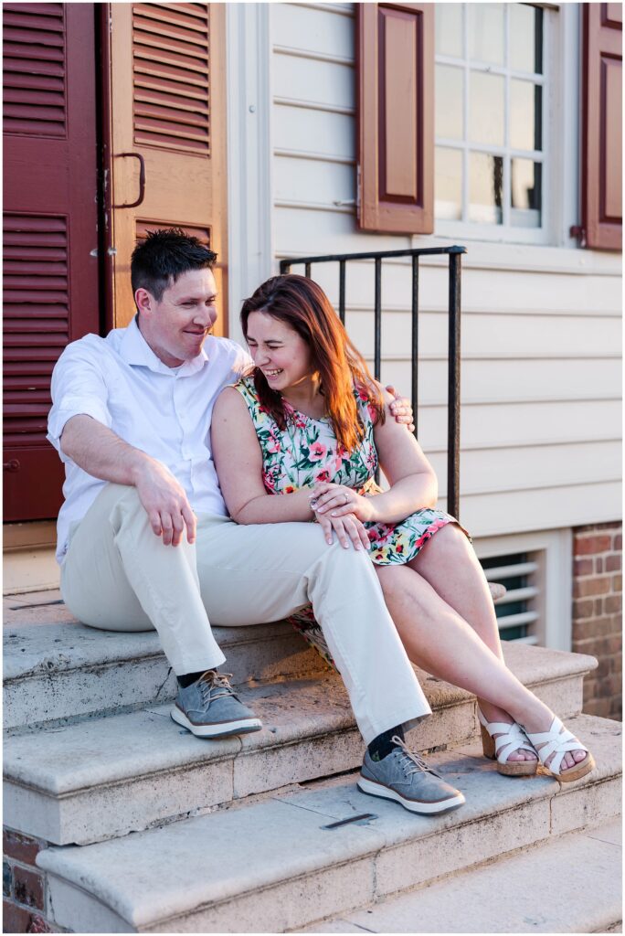 couple cuddles and laughs sitting on steps